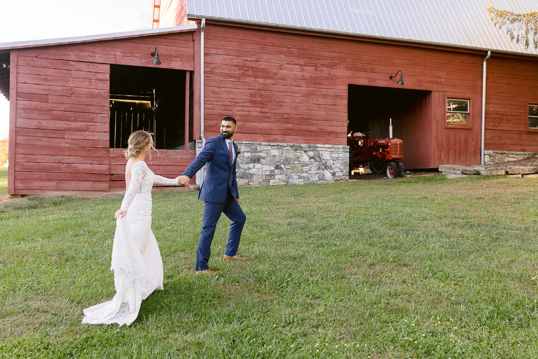 A couple walking past the red barn